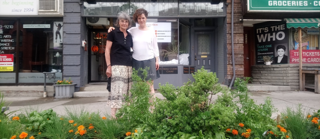 Volunteer Gardener and BIA Member stand behind the street garden they collaborated on.